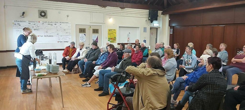 An audience watching the cookery demonstration